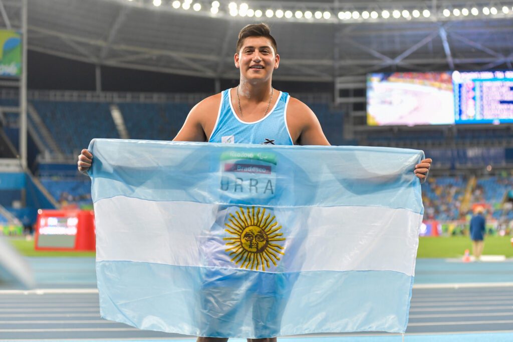 Hernan Urra sosteniendo una bandera Argentina.